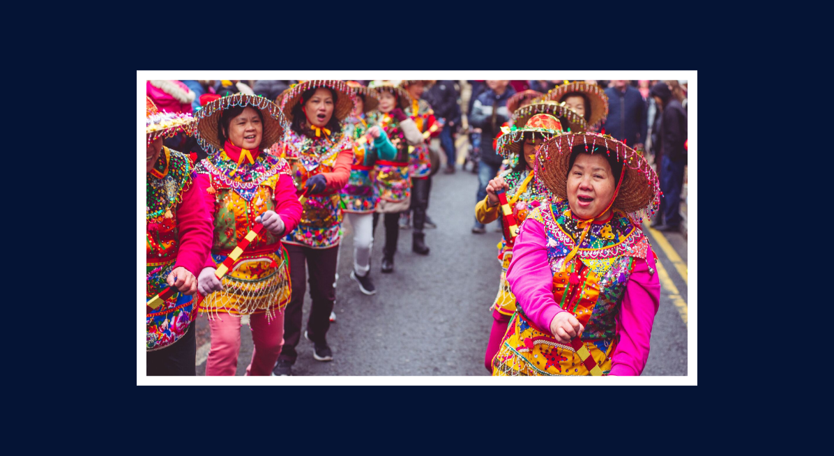 1 Colourful Chinese New Year parade with performers in traditional dress marching through the city.