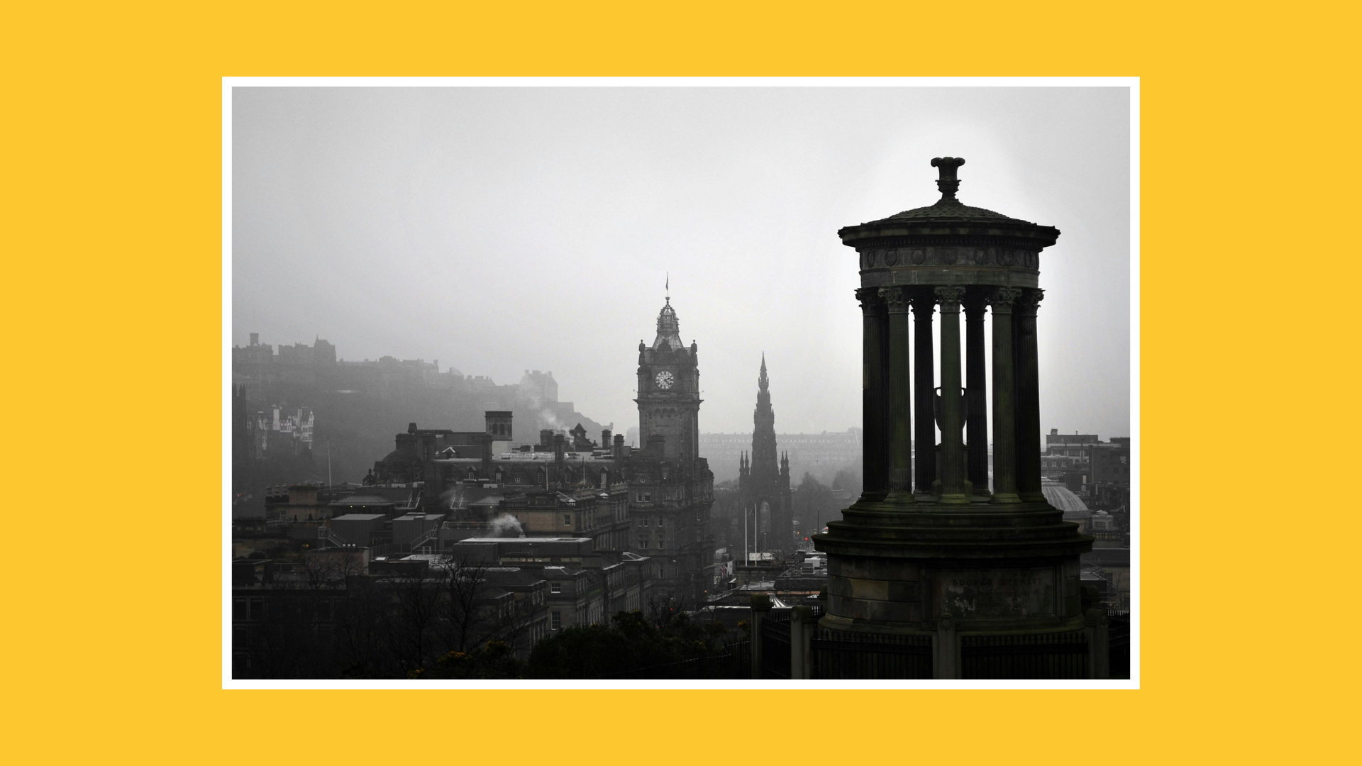 Black and white view of Edinburgh cityscape with the Scott Monument and Balmoral clock tower rising above the city