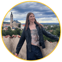 Callum Borkowski, a second-year Combined Honours student and 2025–26 Student Content Creator at Newcastle University, smiling on a rooftop with a scenic view of a historic town in the background.”-1
