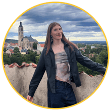 Callum Borkowski, a second-year Combined Honours student and 2025–26 Student Content Creator at Newcastle University, smiling on a rooftop with a scenic view of a historic town in the background.”-2