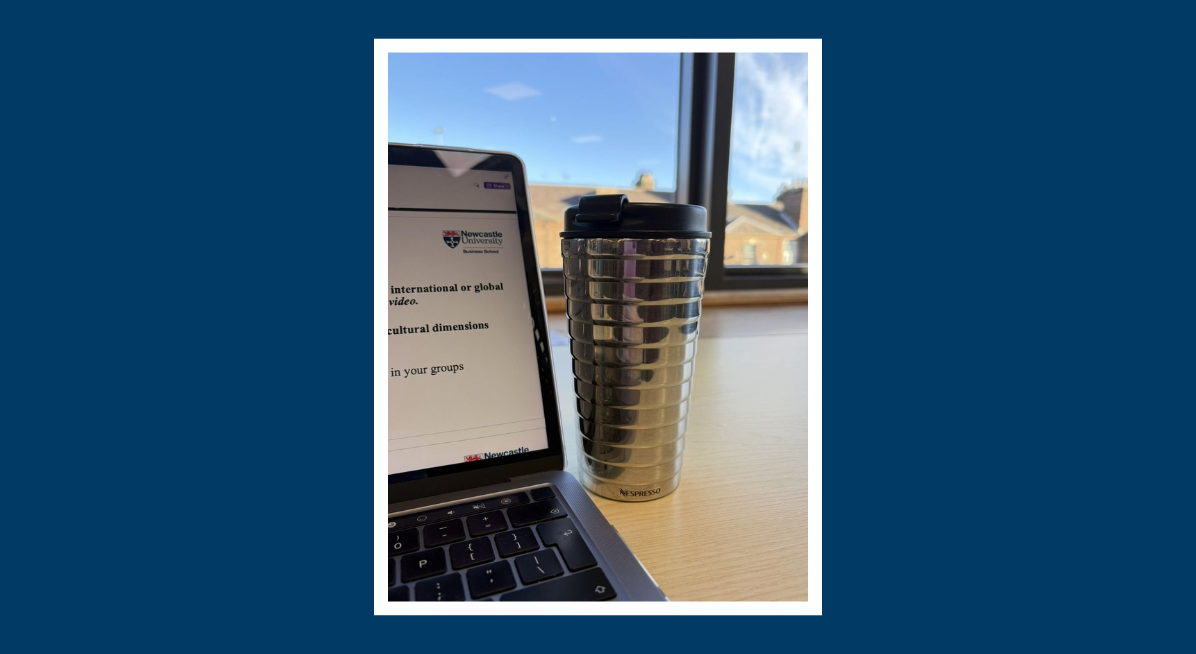 Coffee next to laptop in library