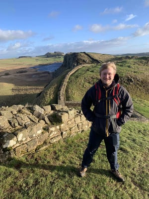 Ned standing in front of Hadrian's Wall