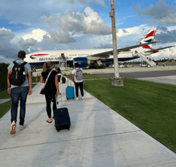 People with luggage walking to British Airways flight