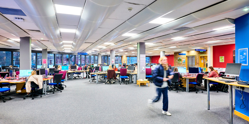 Student walking out of Library computer cluster