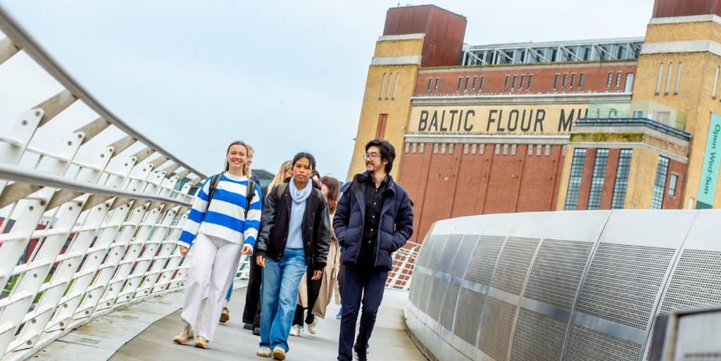 Students walking across Millennium Bridge with Baltic in background