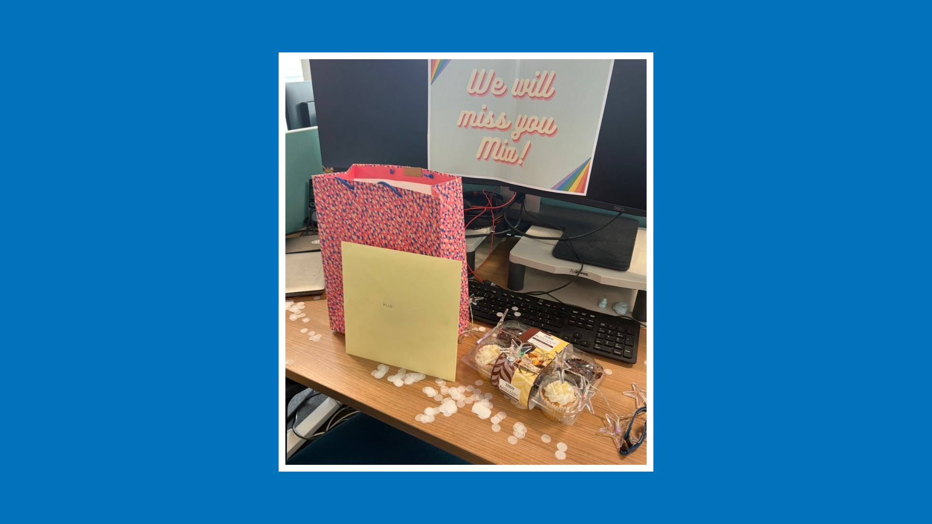 Desk decorated with cakes, cards and gifts for a placement student leaving celebration.
