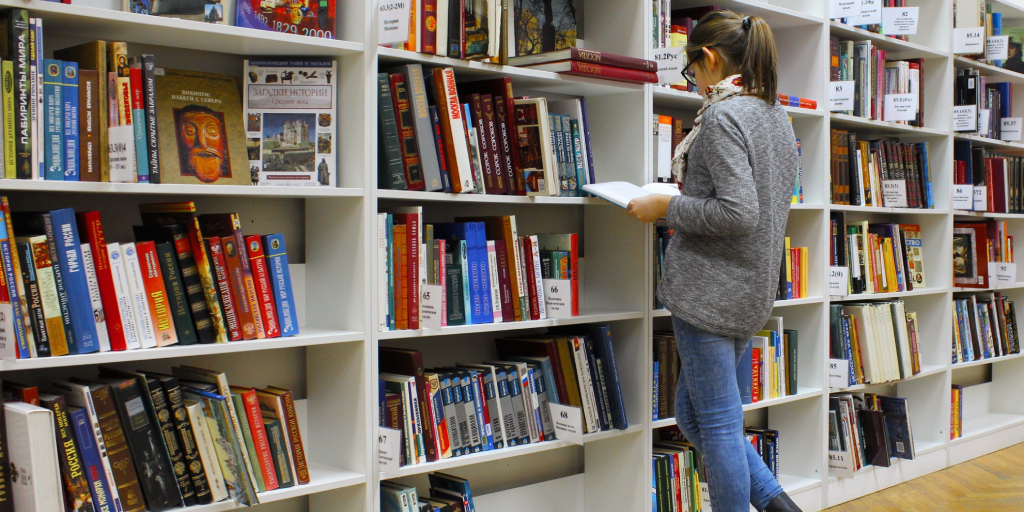 university_libraries_help_newcastle_girl_looking_for_book