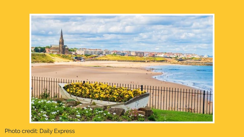 Tynemouth beach scene with rowing boat looking over longsands beach