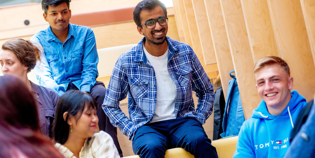 Zaheer taking part in iLab smiles at camera amongst other students