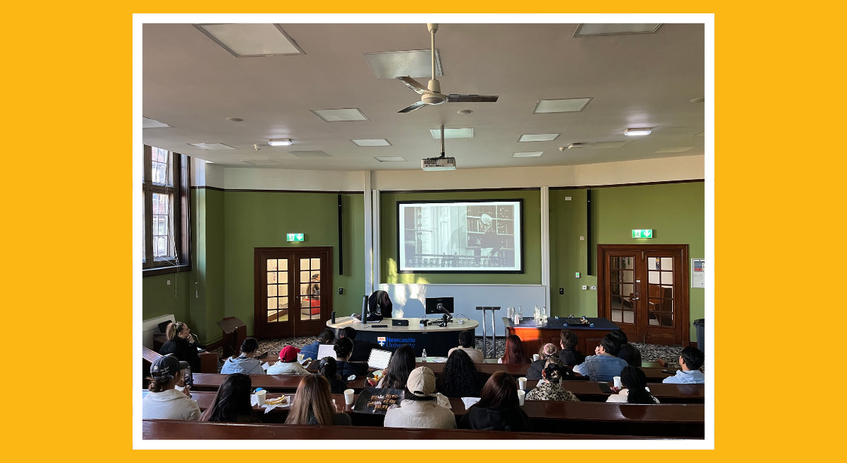 interior of the Lit and Phil, showing a lecture theatre with a film on a screen