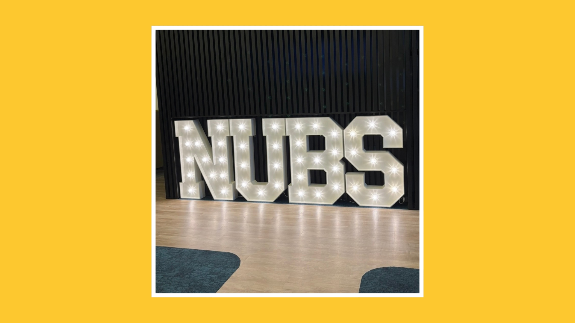lluminated NUBS letters displayed inside Newcastle University Business School.