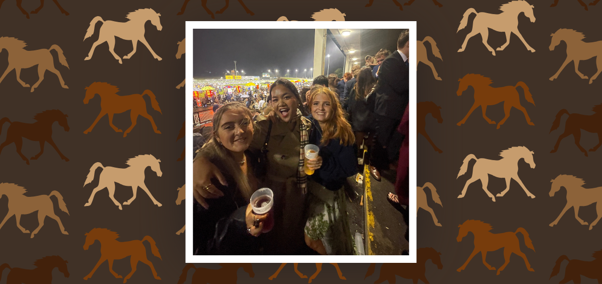 3 girls holding drinks at the racecourse 