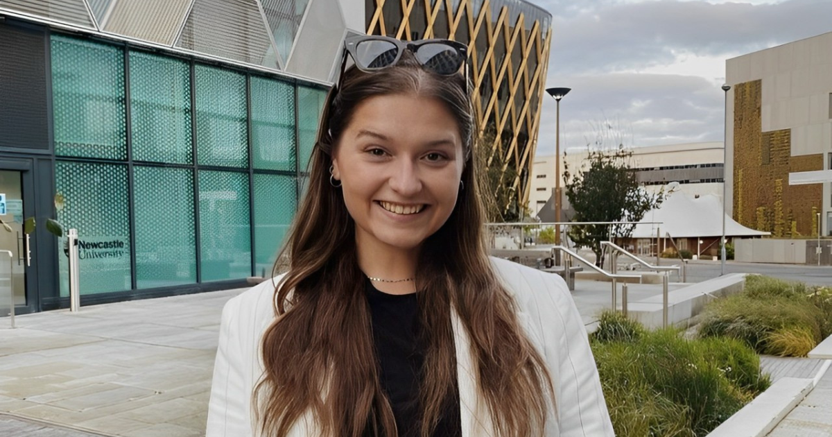a photo of Lenka in front of some buildings