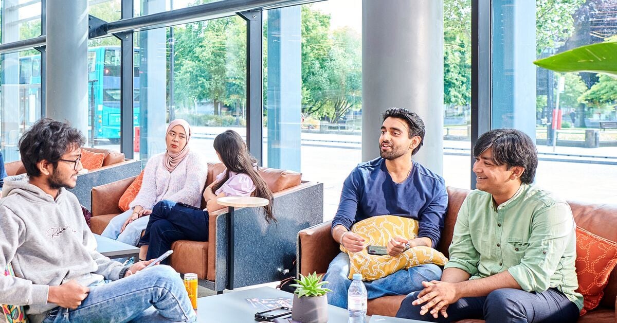 3 male students sitting down speaking 