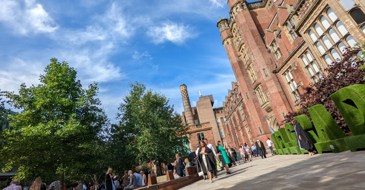 Newcastle University Campus in the Sun with Students in Graduation Gowns Outside
