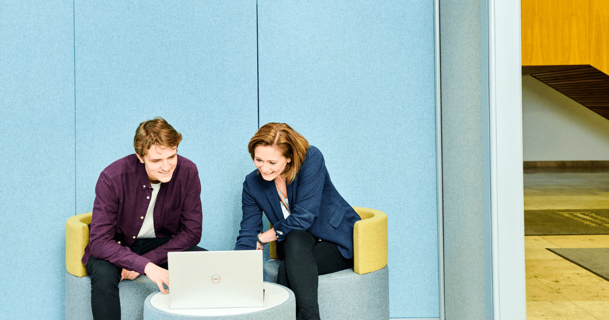 Student with colleague looking at laptop