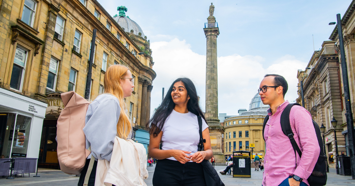 Students stood chatting with Monument in the background