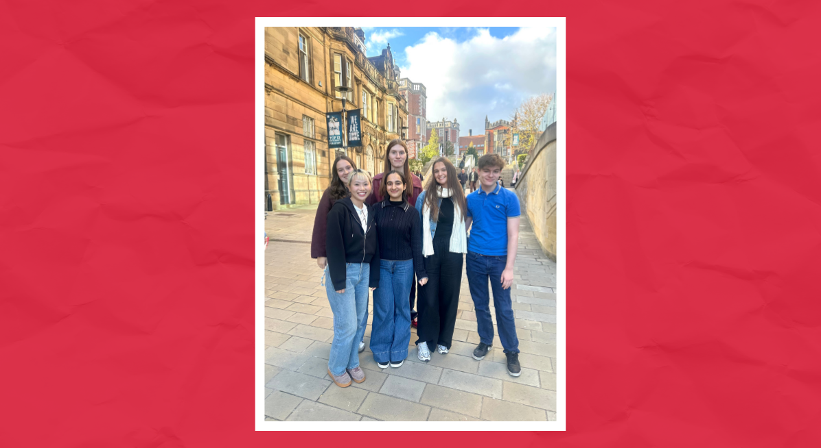 The 2025–26 Newcastle University Student Content Creators standing together and smiling on campus, with historic sandstone buildings and blue skies in the background